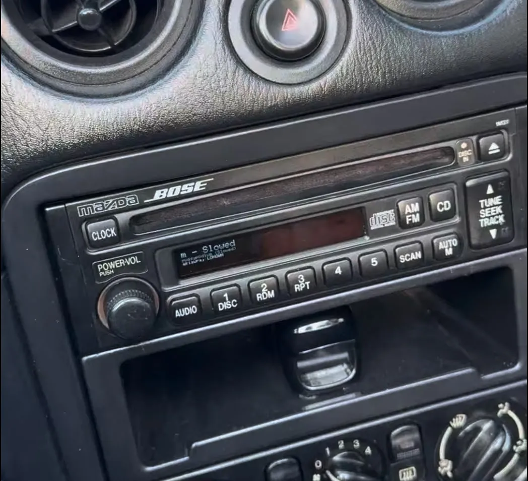 The display fitted into the Miata’s Bose head unit, showing the current track